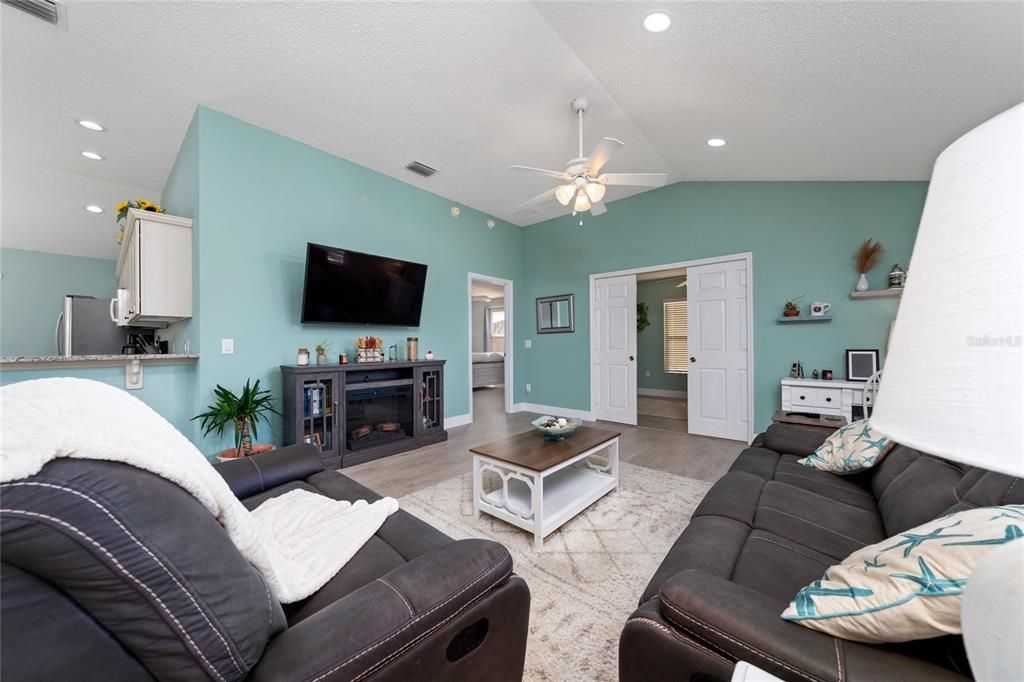 Open living area with plenty of seating room! Primary bedroom door is on left and double doors for the third bedroom/den.