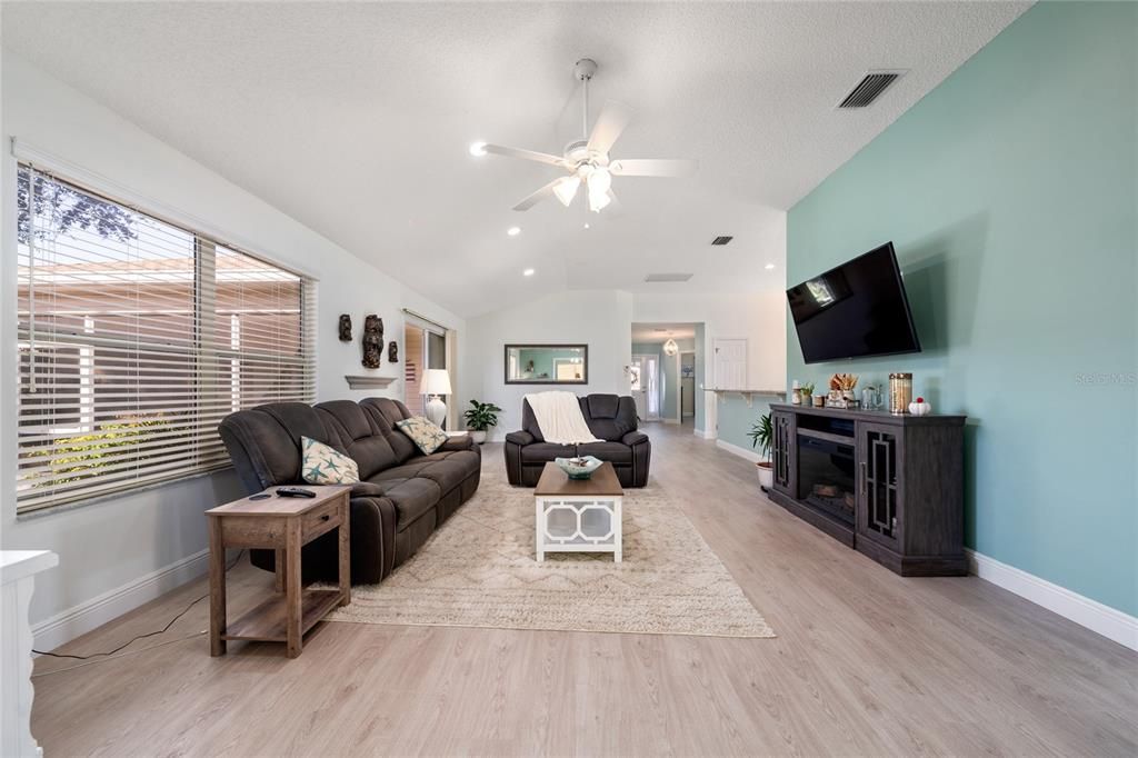 Living/dining open layout with eat-in kitchen to the right and outdoor patio to the left.