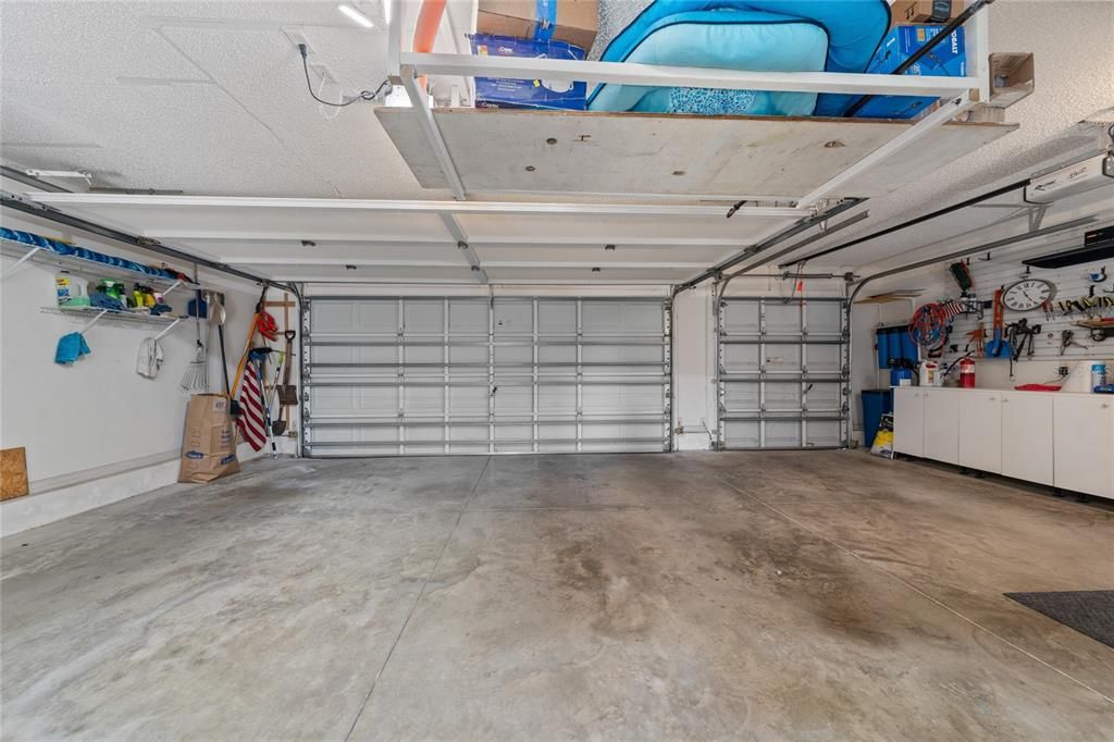 The 2-car and golf car garage offers an abundance of space, shelving and storage!