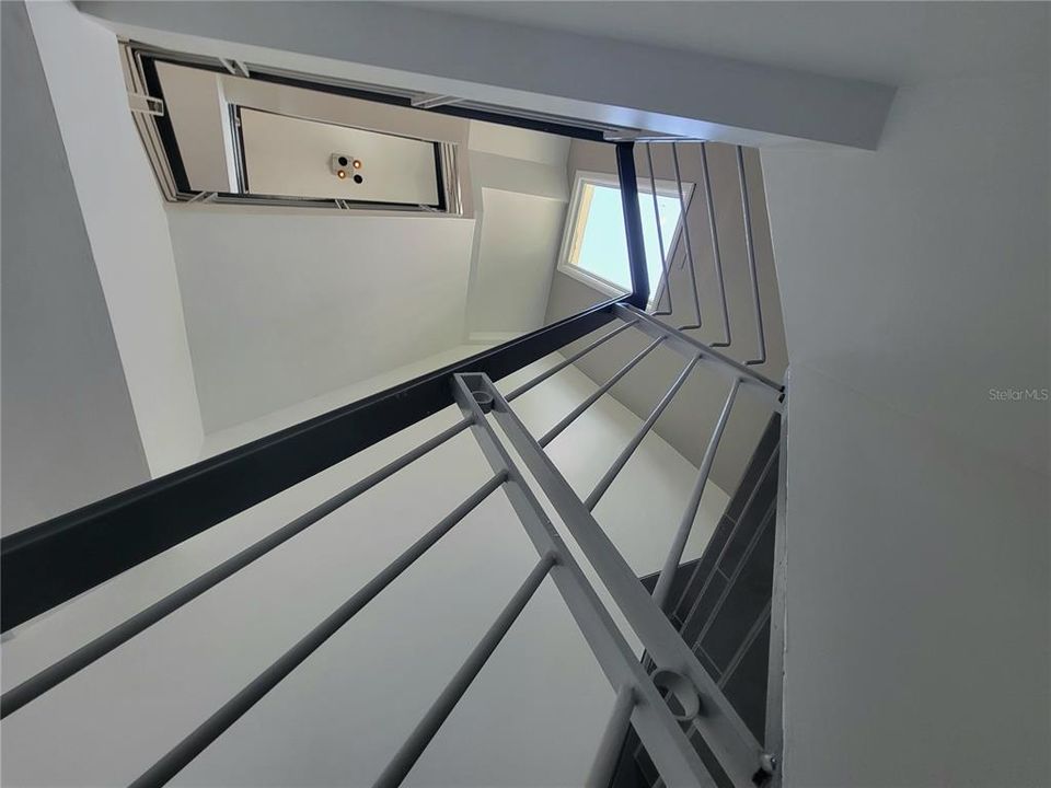 Interior staircase leading to the residential and attic areas