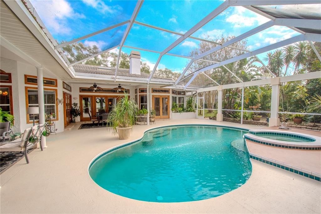 The screened in lanai features a pool and spa.