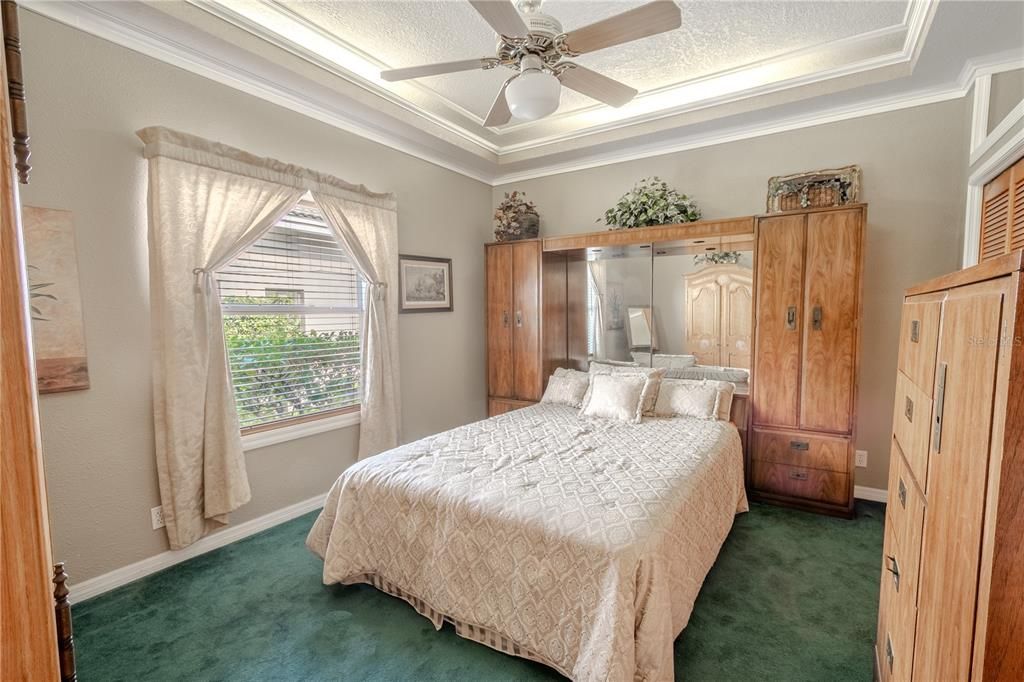 Bedroom 4 features a tray ceiling with ceiling fan, and a built in closet.