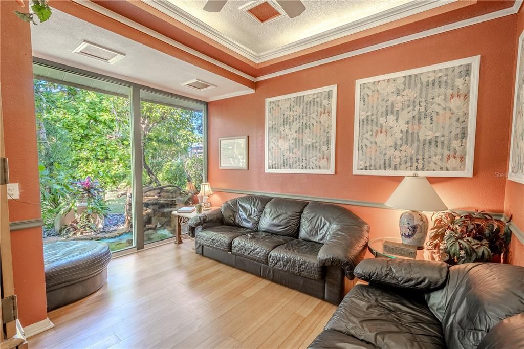 The bonus room features bamboo flooring, and a tray ceiling with ceiling fan.