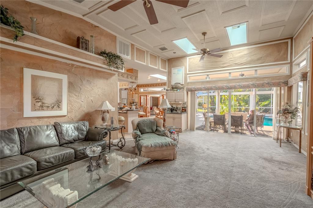 The family room is framed by a wall of glass doors that open to the lanai.