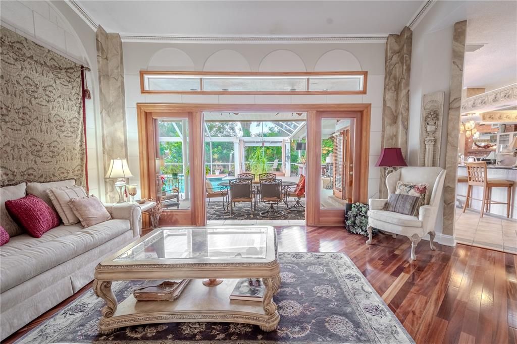 Beautiful glass doors and windows frame the resort style pool and grounds.