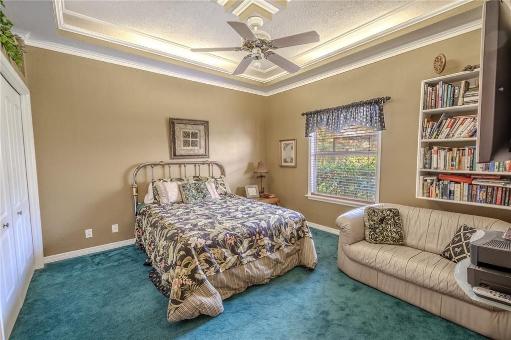 Bedroom 3 features a tray ceiling, crown molding and a built-in closet.