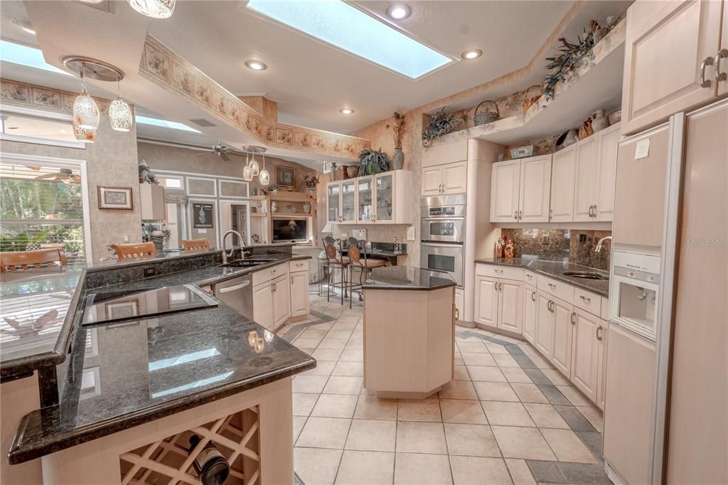 The kitchen features a sky light, a movable island and a built in wine rack.