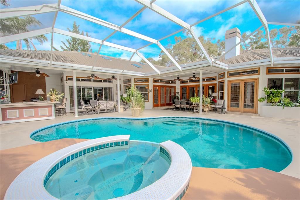 The screened in lanai features a pool and spa.