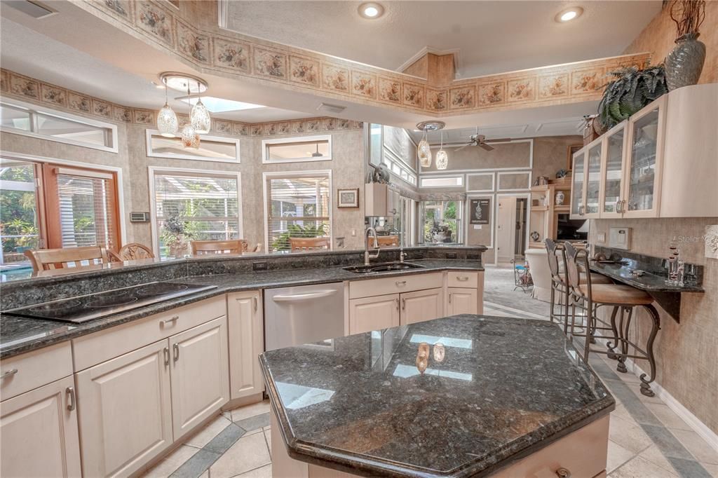 The kitchen sink and island faces the pool and garden.