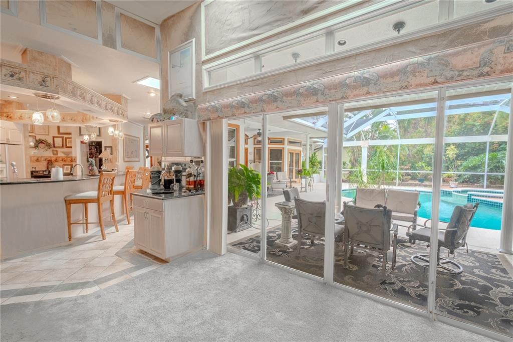 The family room is framed by a wall of glass doors that open to the lanai.