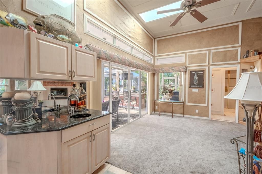 The kitchen opens to the family room with a wet bar.