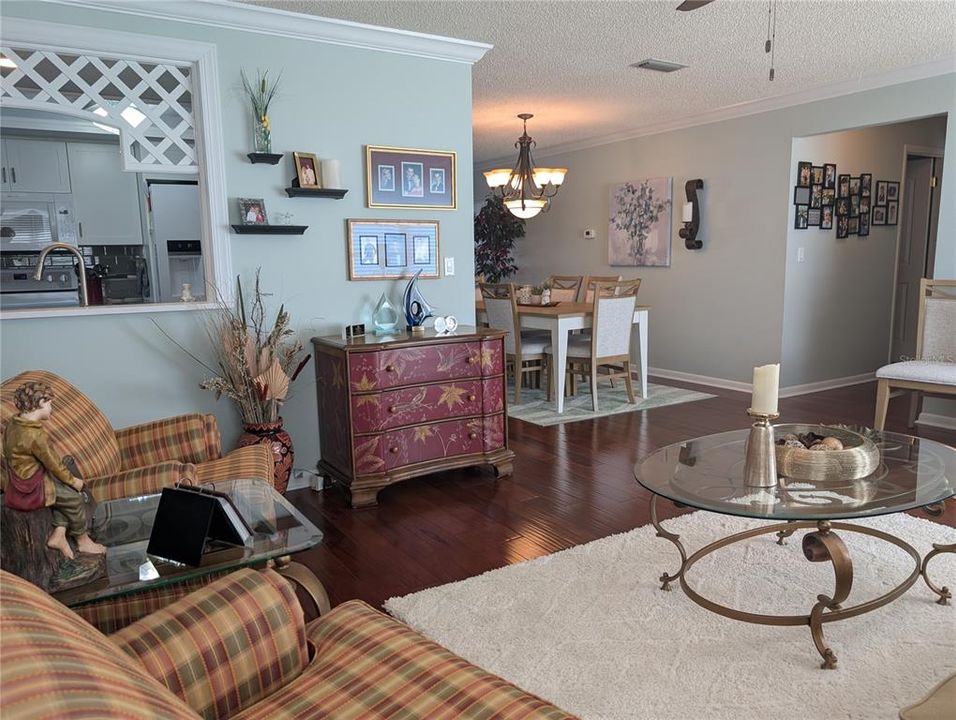 Family room view of dining room, pass thru window to kitchen and hallway.