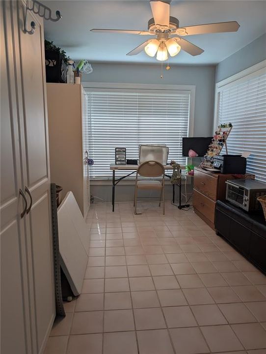 Bonus room is versatile space available to fit any family's needs.  To left is a door to access the Florida room.  To right is an exterior exit to side yard.