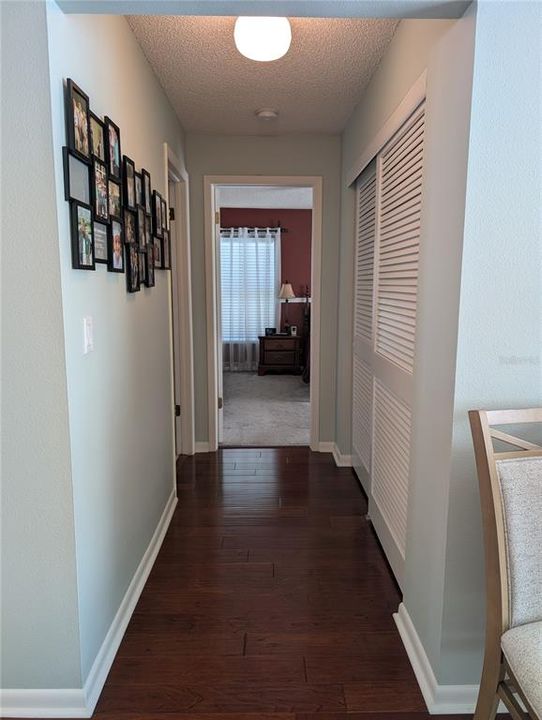 Split floor plan provides private sleeping areas for both bedrooms. Primary Bedroom Suite shares a hallway with the interior laundry on the left.  Enormous hall closet on right provides cherished extra storage.