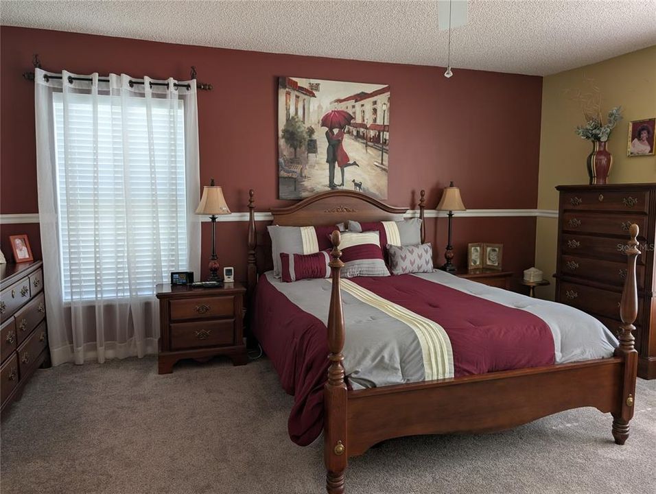 Spacious carpeted primary bedroom.