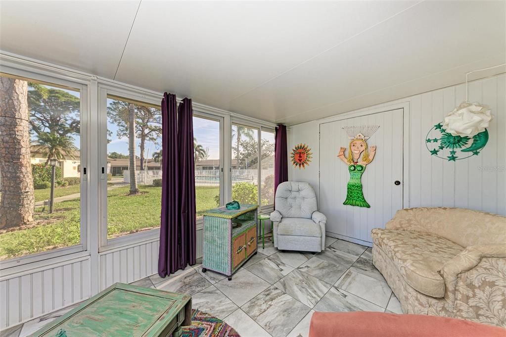 Enclosed Porch with the tucked in laundry room