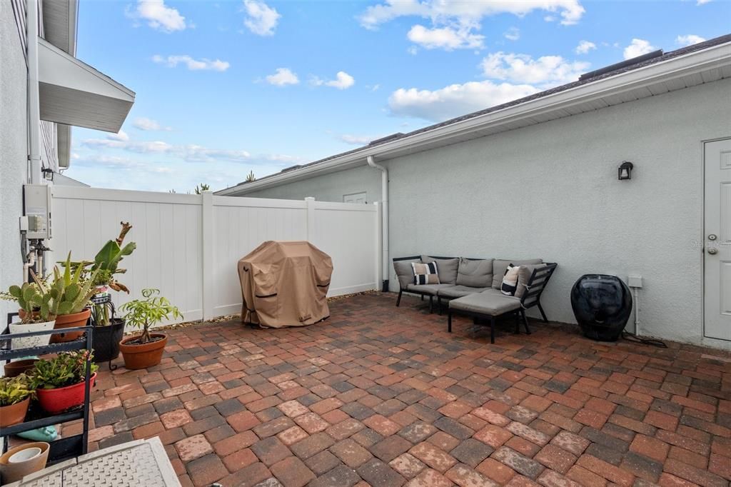 Pavered Courtyard in back of home, door on right of photo opens to private 2 car garage