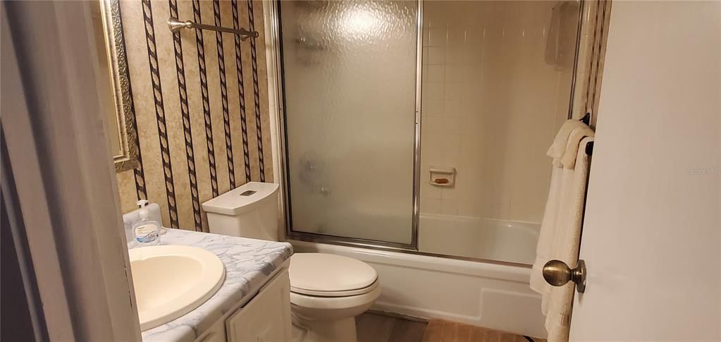 bathroom with shower and tub