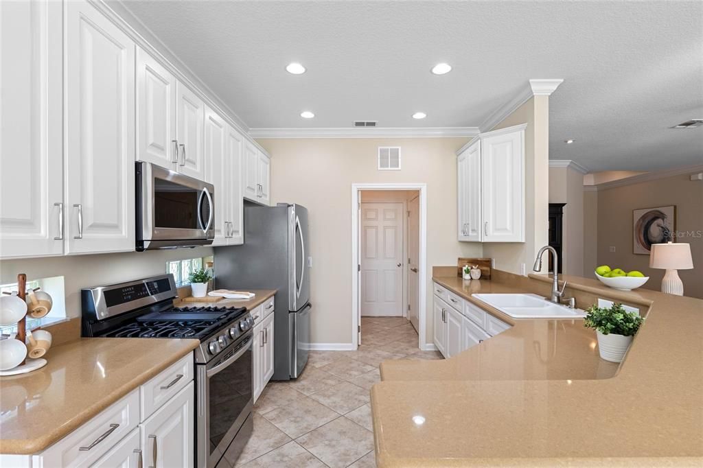 Kitchen w/ Quartz countertops, Pull-out shelf & a 5-burner natural gas range