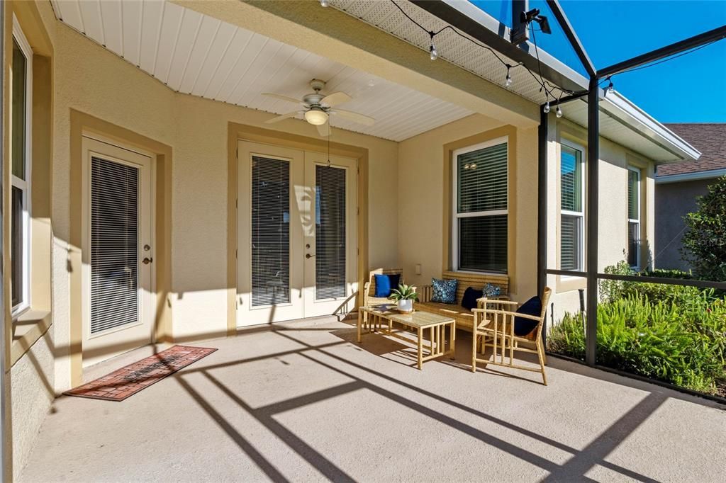 Screen enclosed covered lanai w/ French doors that lead into home