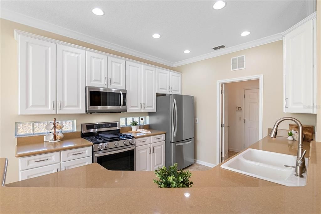 10' x 12' Kitchen w/ 42" wood cabinetry, Quartz countertops, exterior glass block inserts & stainless steel appliances