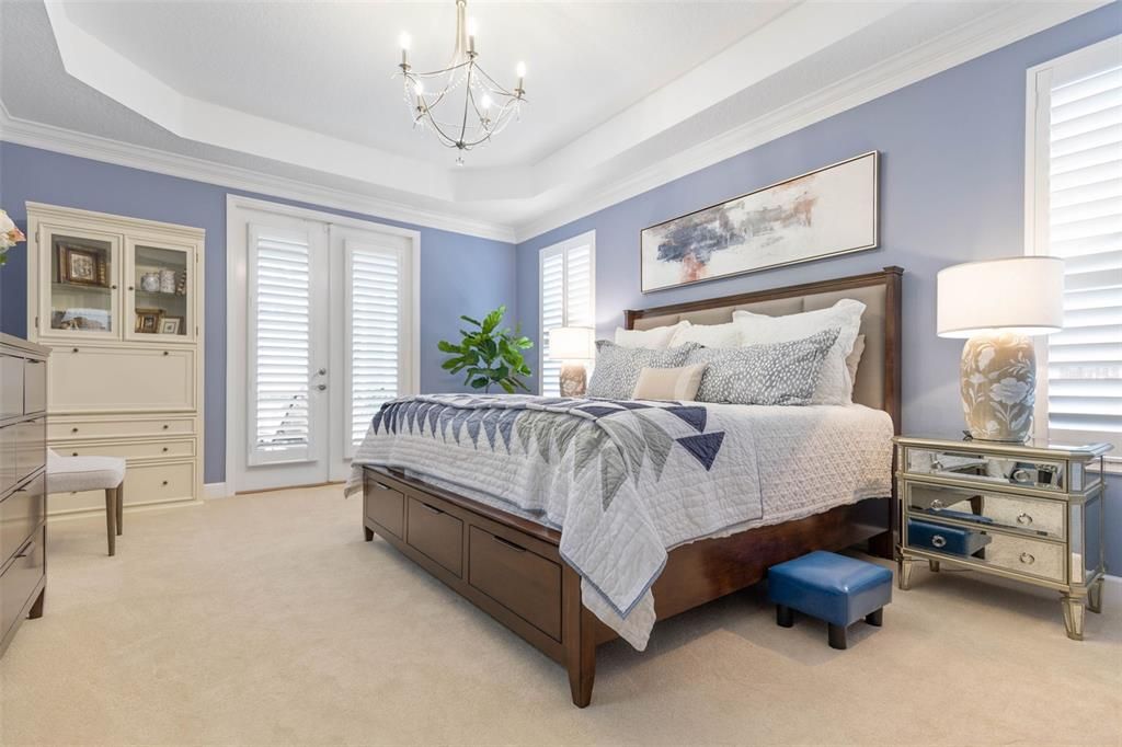 Primary bedroom with French doors to pool.