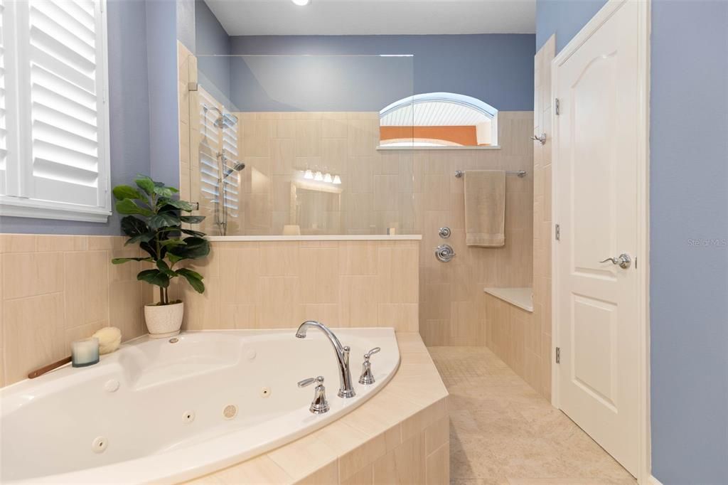 Large whirlpool soaking tub in primary bath.