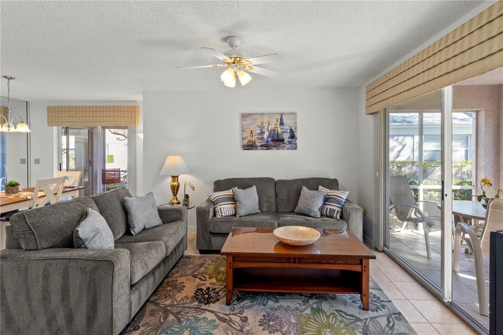 The living room also features sliding glass door out to the screened-in back patio.