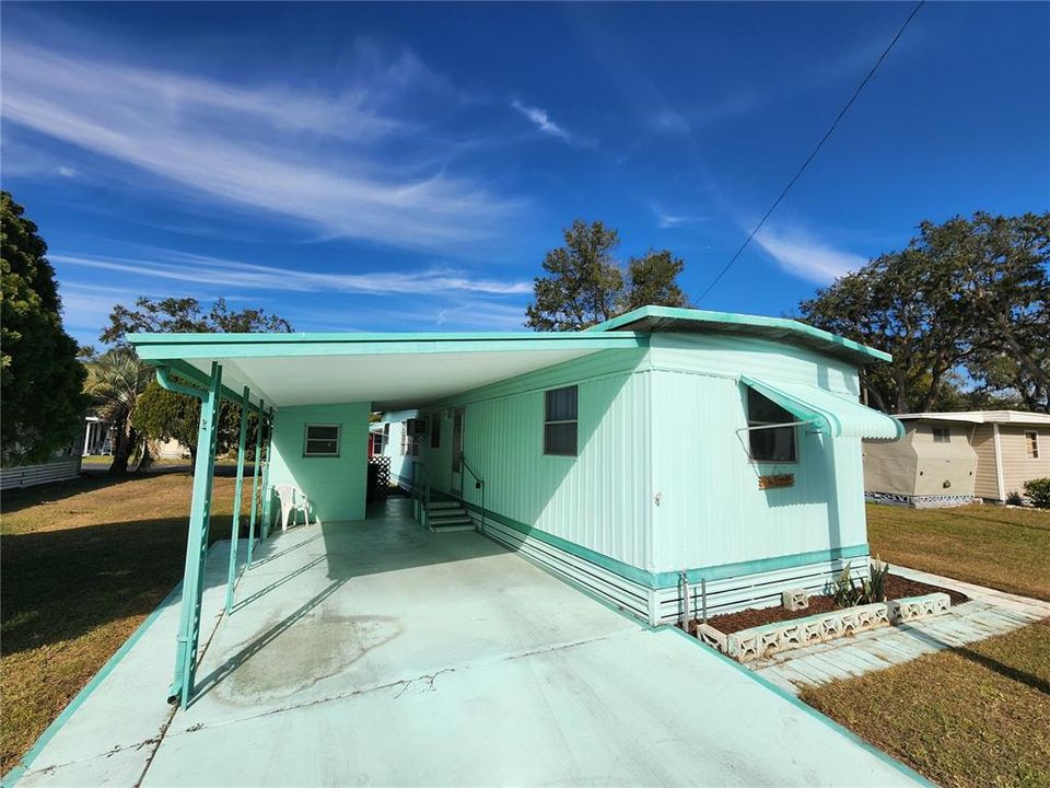 South side. Driveway & carport.