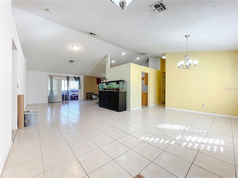 The combo living room and dining room. The split bedroom floor plan has 2 bedrooms on the left and the primary bedroom on the right.