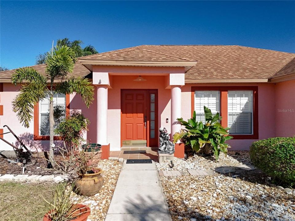 Exterior front entryway. The sidewalk with the nice landscaping