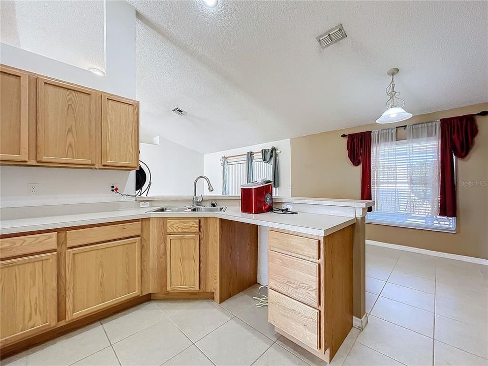 Kitchen has lots of cabinets and counter space.