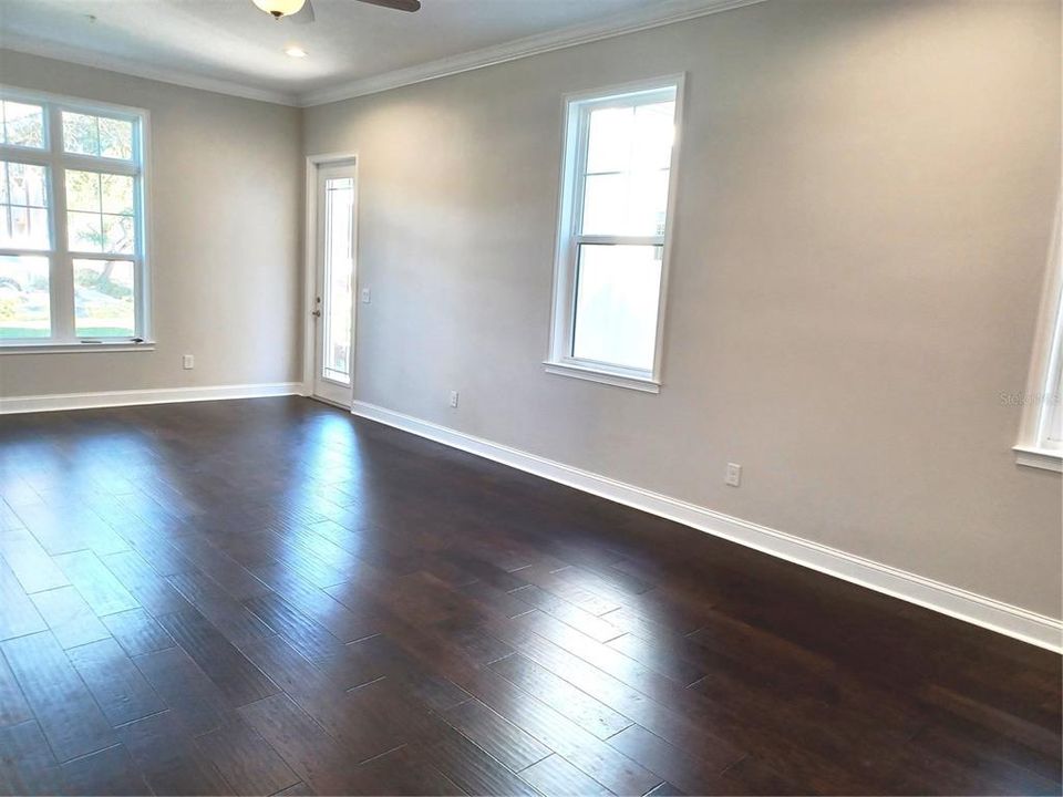 View of large living room from stairs, large front / side window