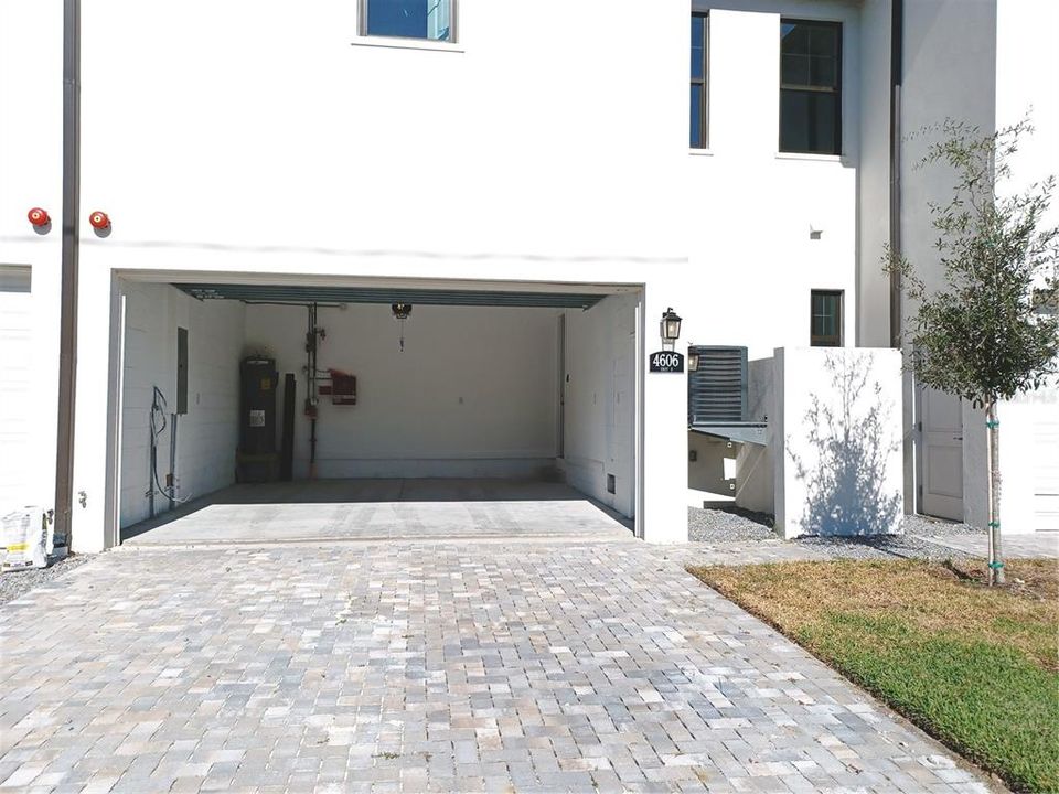 Garage entrance at rear of house offers parking for guests