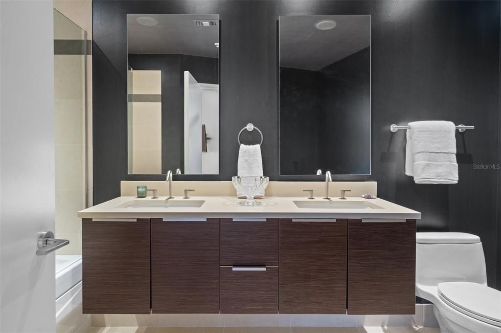 The guest bathroom off of the media room is on the second level features a double-sink vanity.