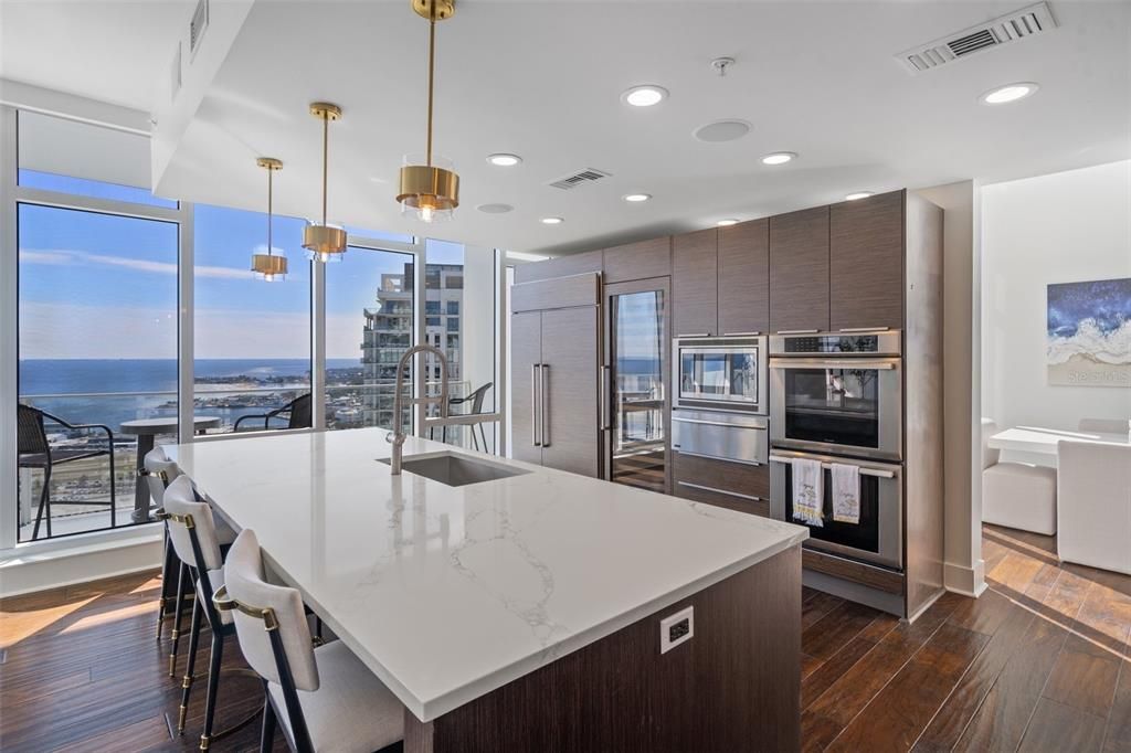 The kitchen offers Top-of-the-line stainless steel appliances, including a built-in espresso machine, microwave, and a double wine refrigerator!