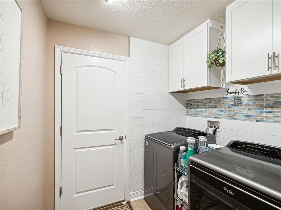 Inside Laundry Room with Cabinets