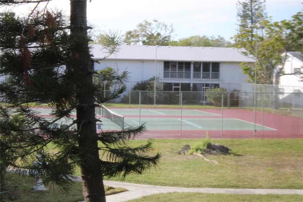 Screened in lanai with pool and tennis court view