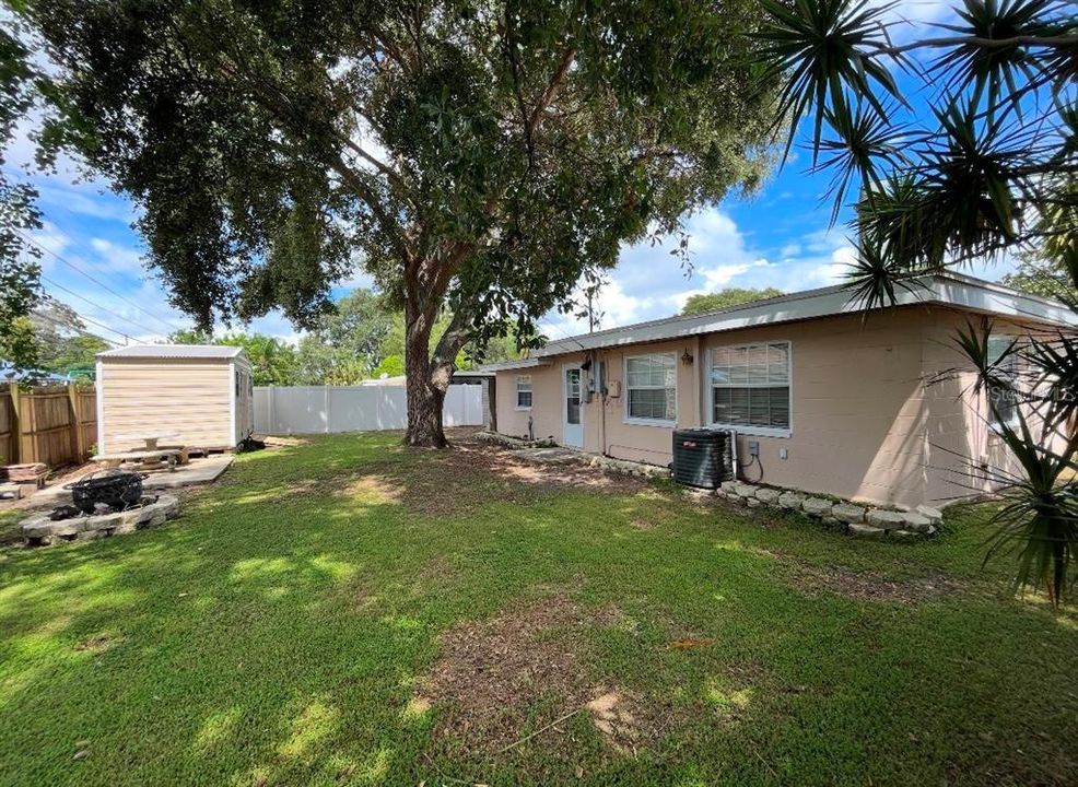 Nice Back yard, picnic table, fire pit and loads of shade with privacy!!