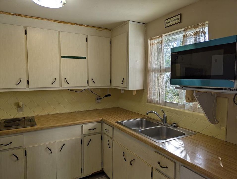 Kitchen has ample cabinet and counter space.  There is a two-burner range.  The kitchen window has views to the yard.