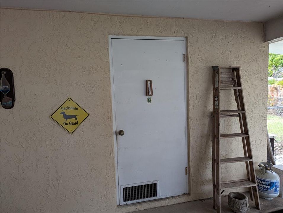 At the end of the covered parking space is a workshop/laundry room.