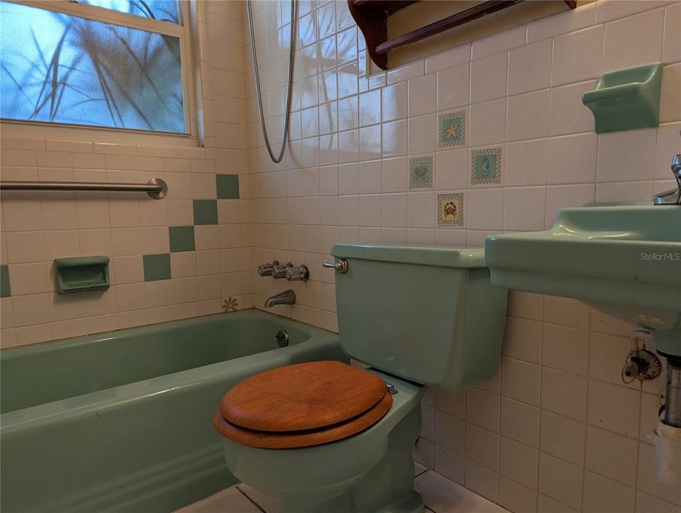 This cute retro bathroom has a shower tub.