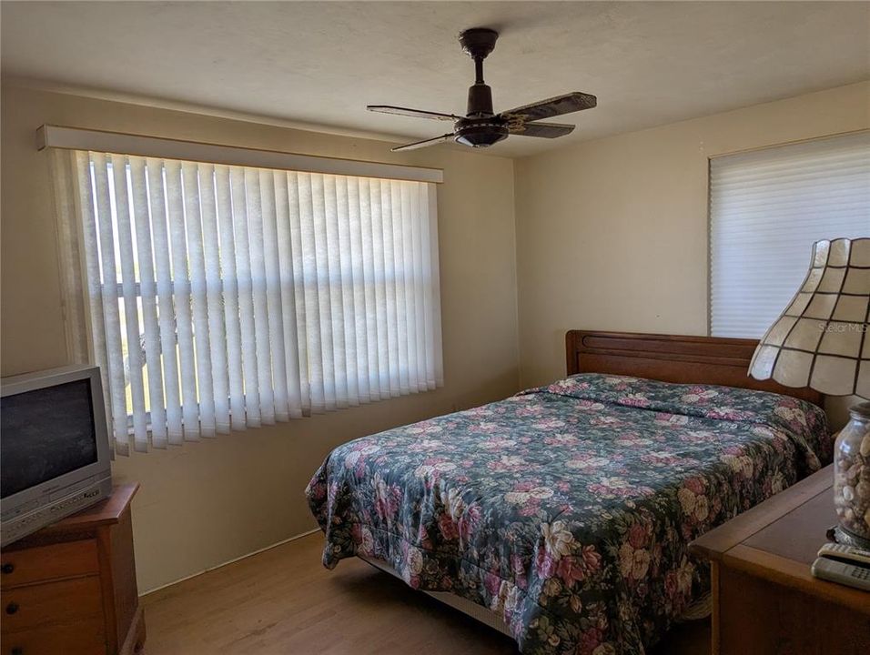 Primary bedroom is spacious with two windows.