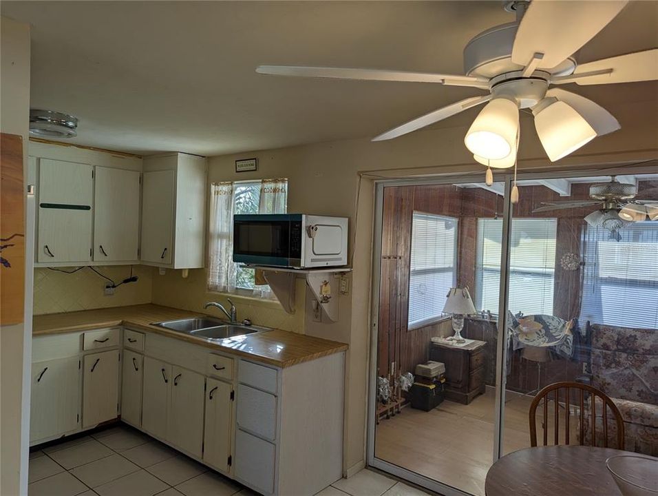 Another view of the kitchen that shows access to the enclosed lanai.  The window over the sink looks into the back yard.