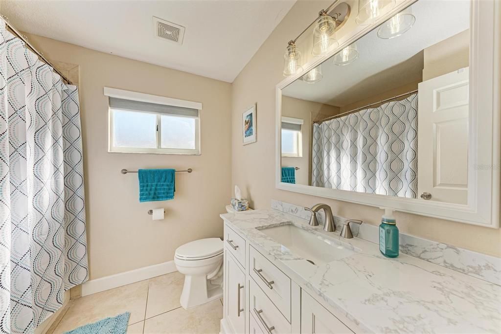 Guest bath with brand new granite counter, refaced cabinets and new fixtures - so pretty!