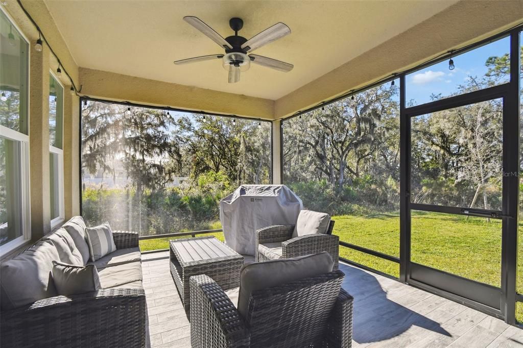 The screened-in patio offers a serene view of the beautiful wooded area, with no rear or left-side neighbors.