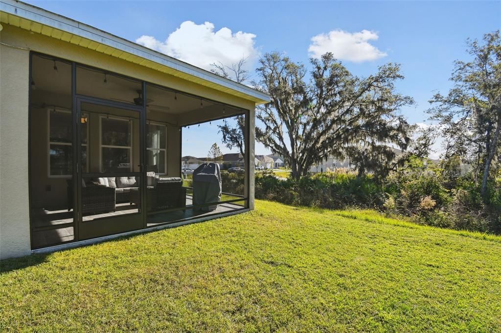 The screened-in patio offers a serene view of the beautiful wooded area, with no rear or left-side neighbors.