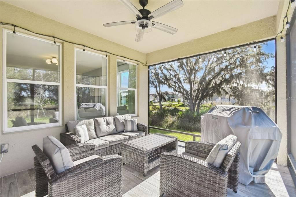 The screened-in patio offers a serene view of the beautiful wooded area, with no rear or left-side neighbors.