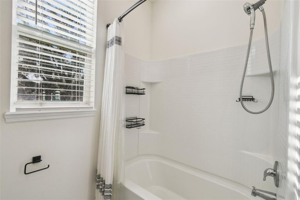 Bathroom 3, located between bedrooms 3 and 4, features a double vanity and a tub/shower combo.