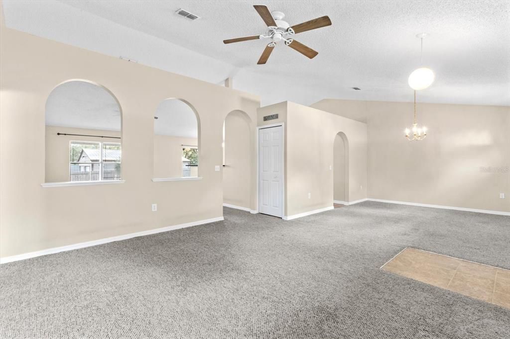 Formal Living & Dining Rooms w/ Vaulted Ceilings & Arched Doorways Throughout